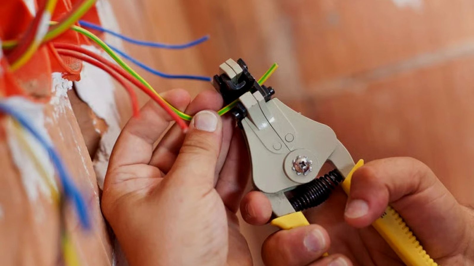 Electrician stripping and repairing electrical wiring